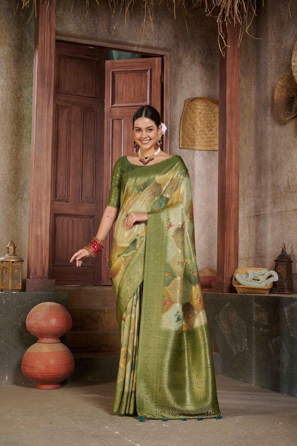 woman standing in Tusser Green Savannah saree.