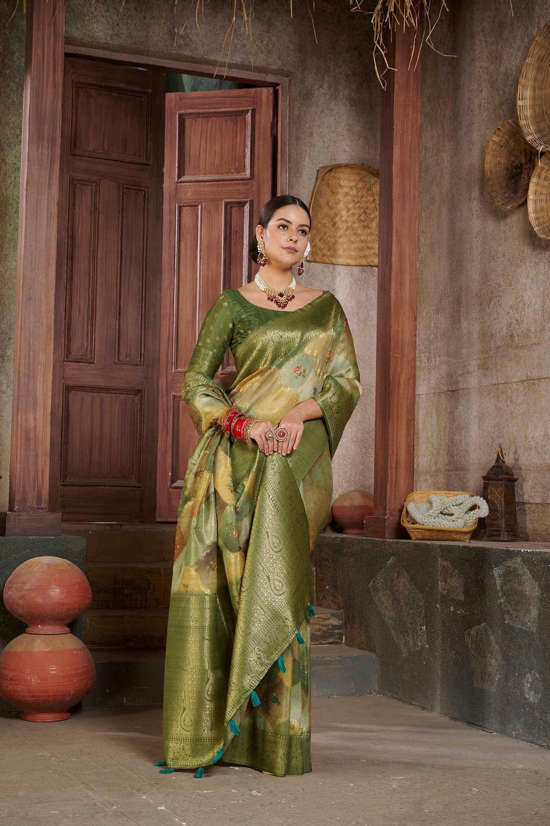 woman standing in Tusser Green Savannah saree.