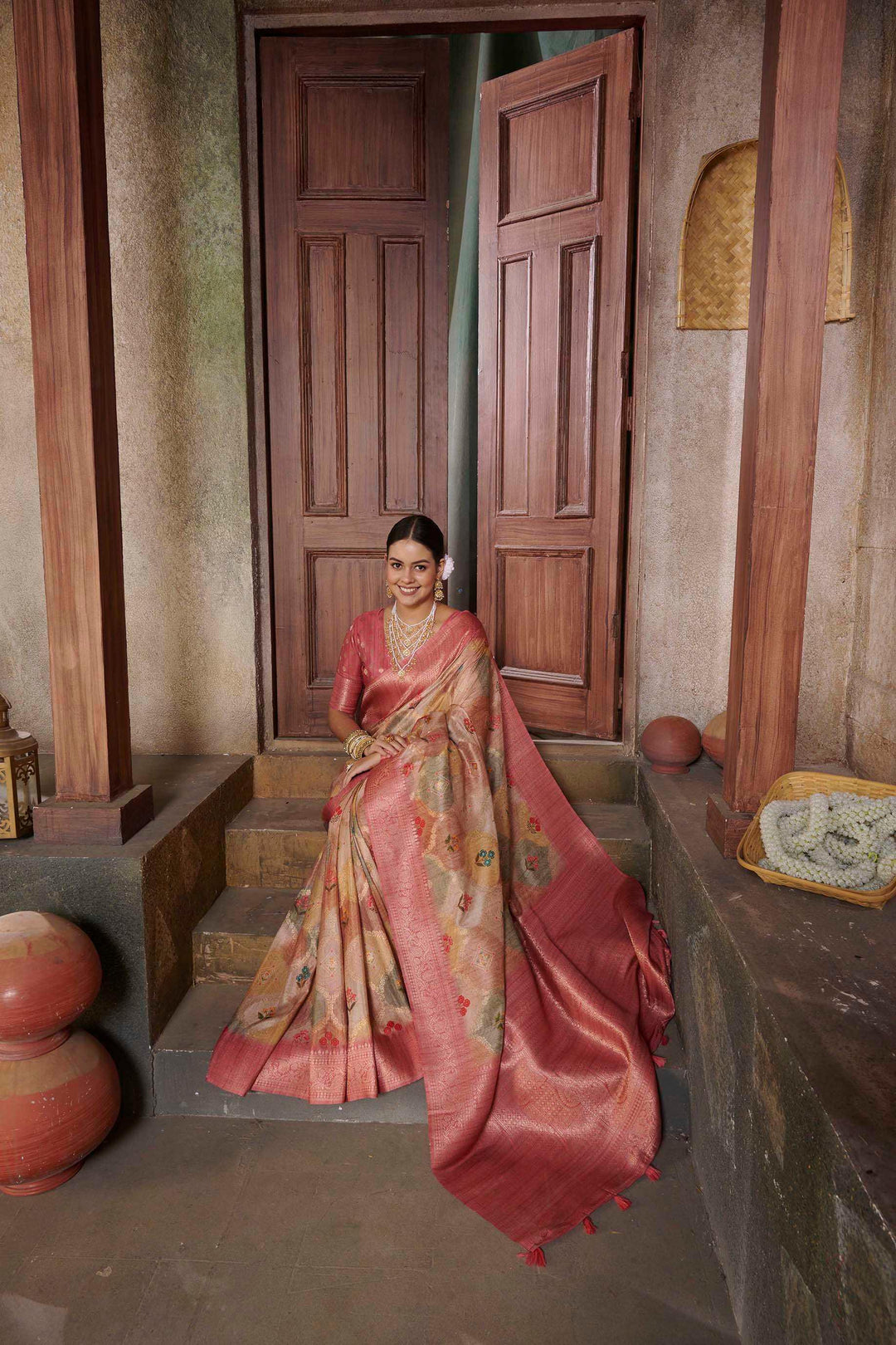 woman sitting on steps in Pink Jcrd Savannah Saree.