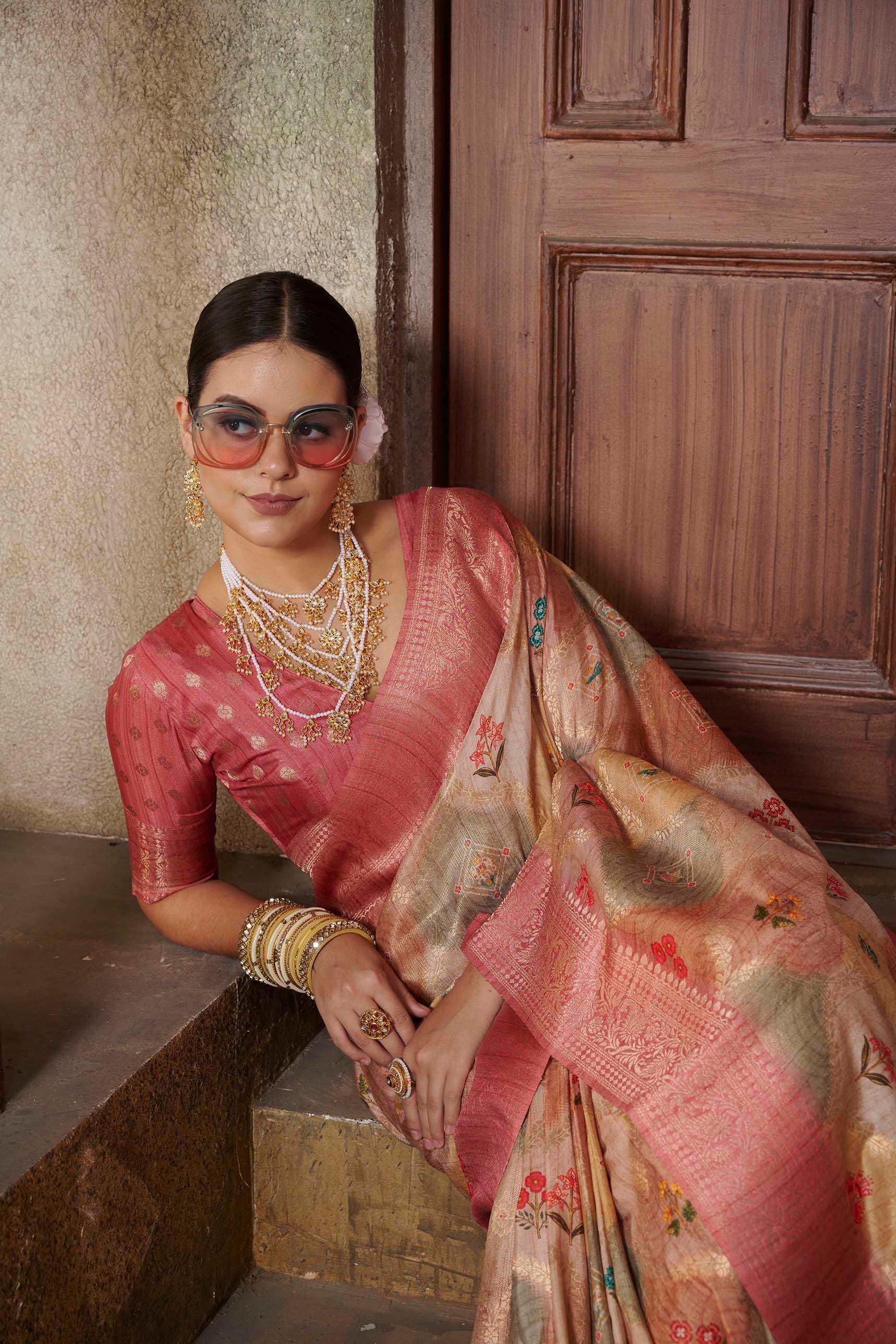 woman sitting on steps in Pink Jcrd Savannah Saree.