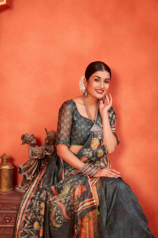 woman sitting in Mehndi Green Designer Pichwai Chanderi Saree.