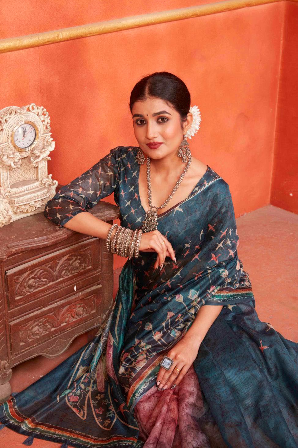 woman sitting in Indigo Designer Pichwai Chanderi Saree.