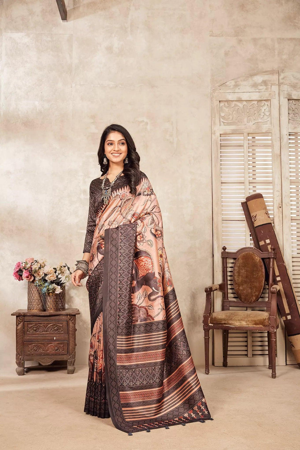 woman standing in Hathi Kalamkari Figer Diya Saree.