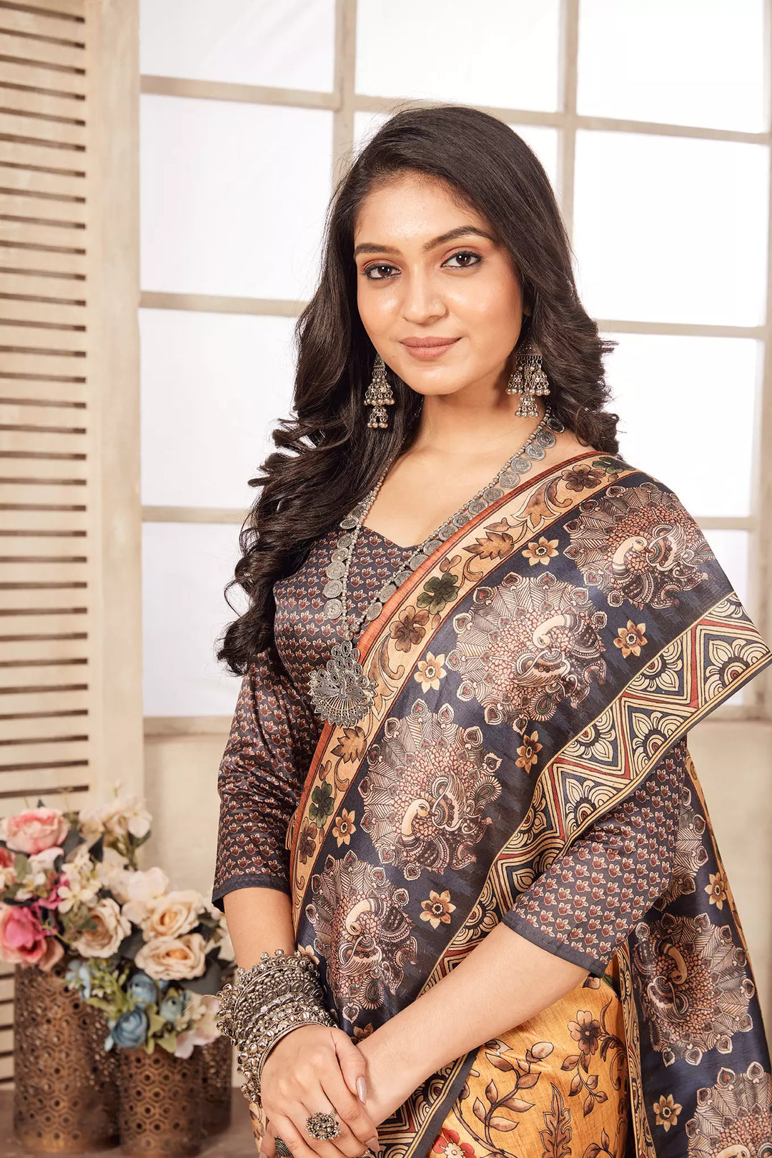 woman standing in Peacock Border Diya Saree.