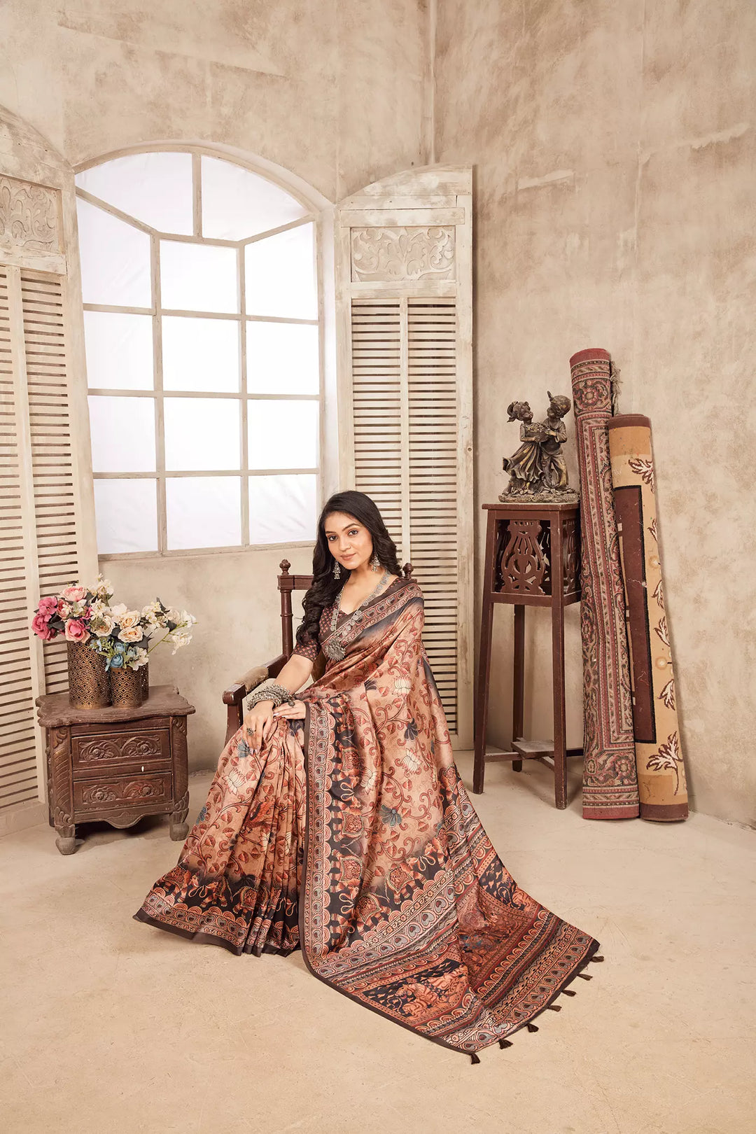 woman sitting on chair in Traditional Kalamkari Figer Diya Saree.