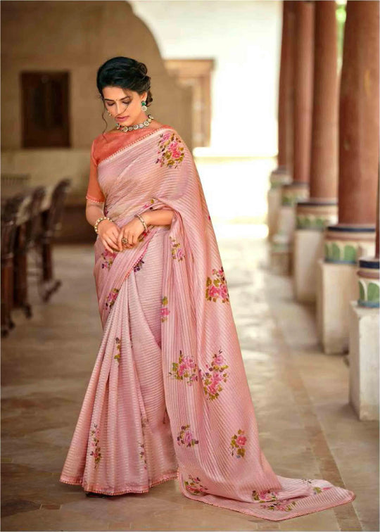 woman standing and looking down in floral crochet saree.