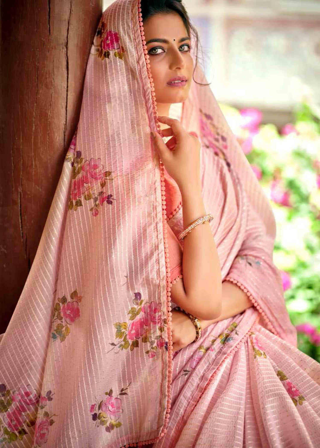 woman sitting in floral crochet saree.