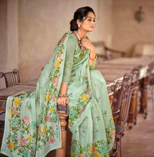 Woman in floral jal crochet saree sitting on bench.