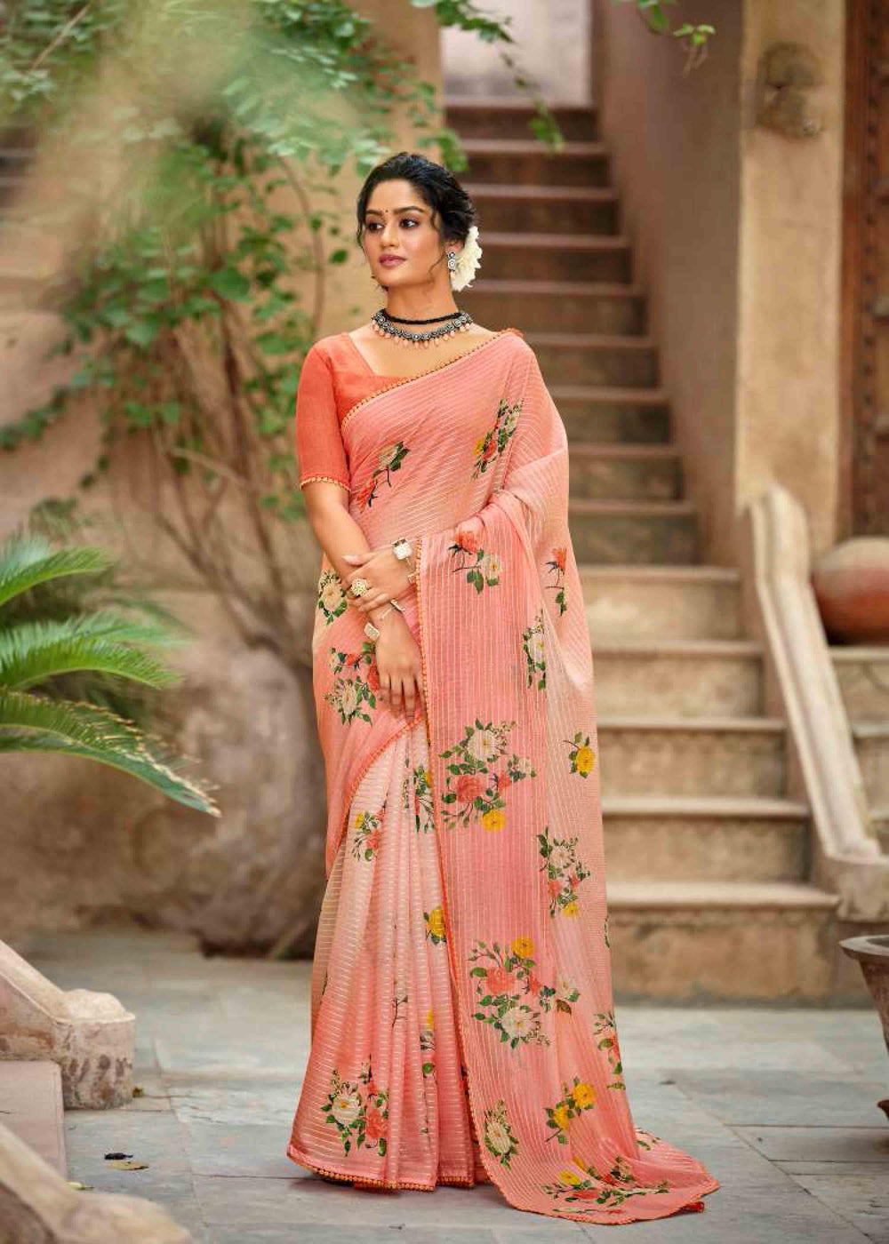 woman standing in floral bunch crochet saree.