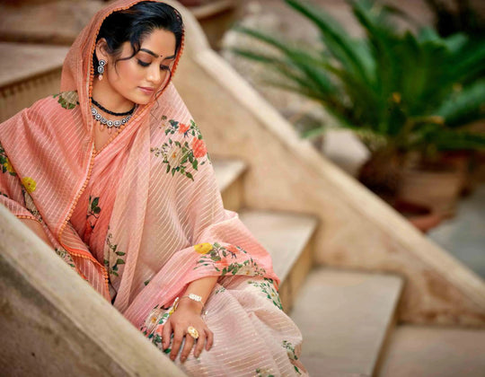 woman sitting on steps in floral crochet saree.