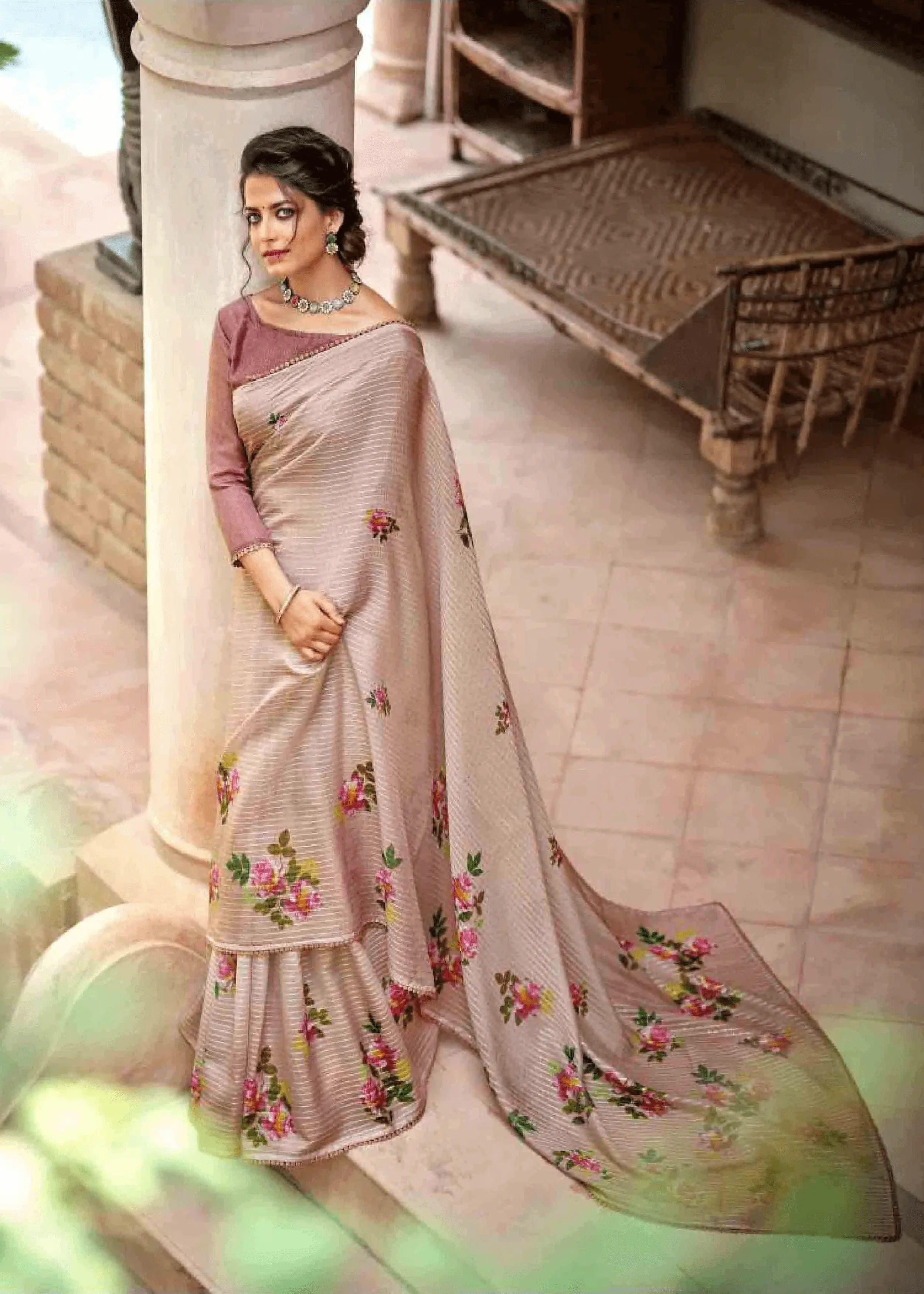 woman wearing a floral crochet saree, standing on a beautiful patio.