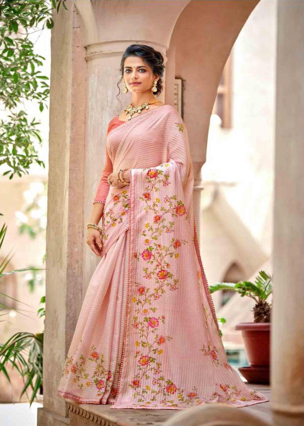 woman standing in floral jal crochet saree.