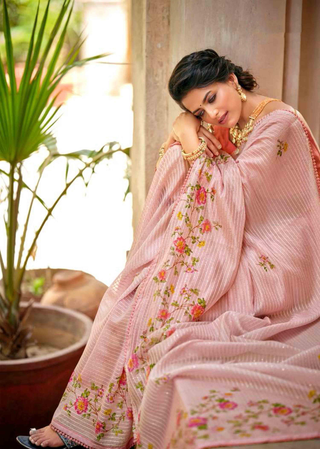 woman sitting in floral jal crochet saree.