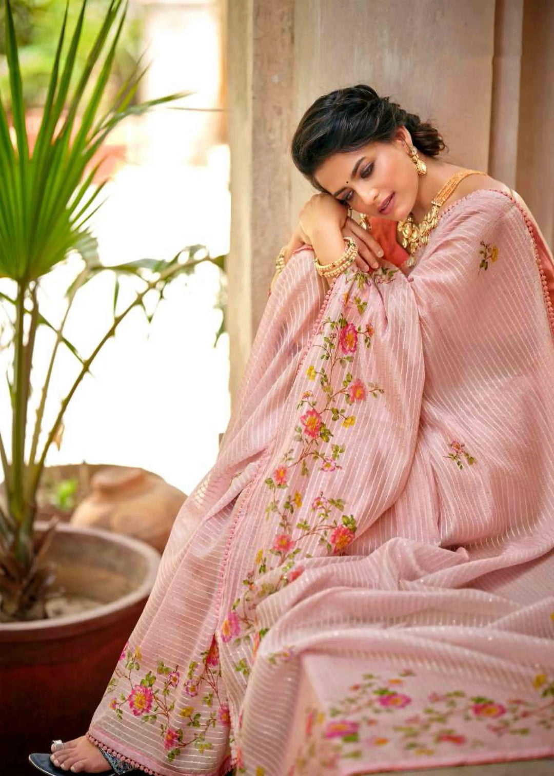 woman sitting in floral jal crochet saree.