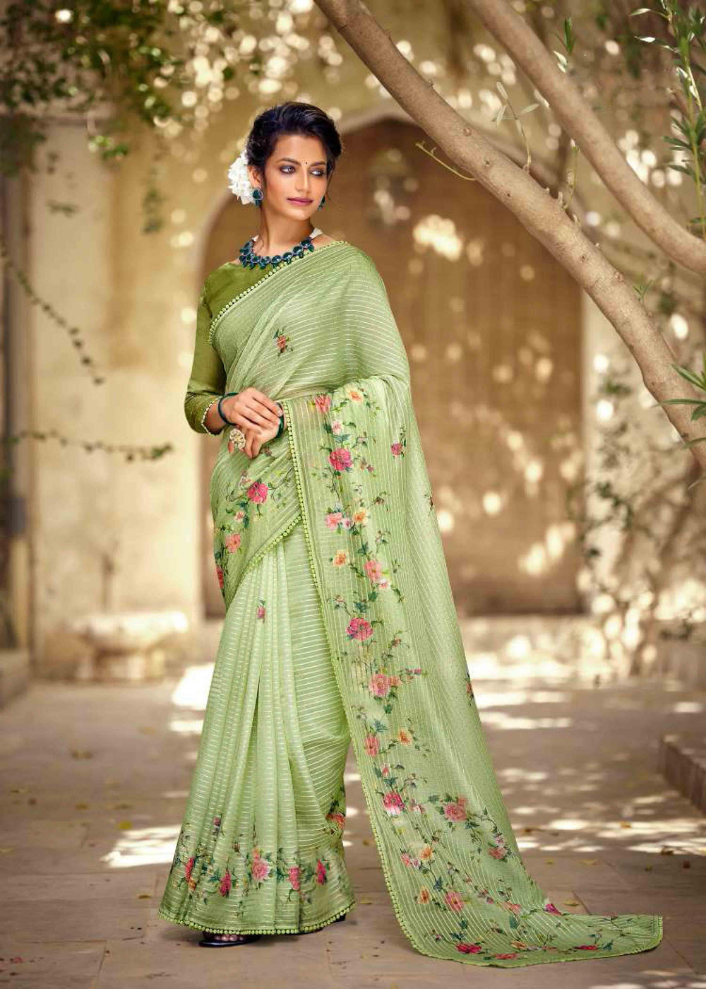 woman standing in light green floral crochet saree